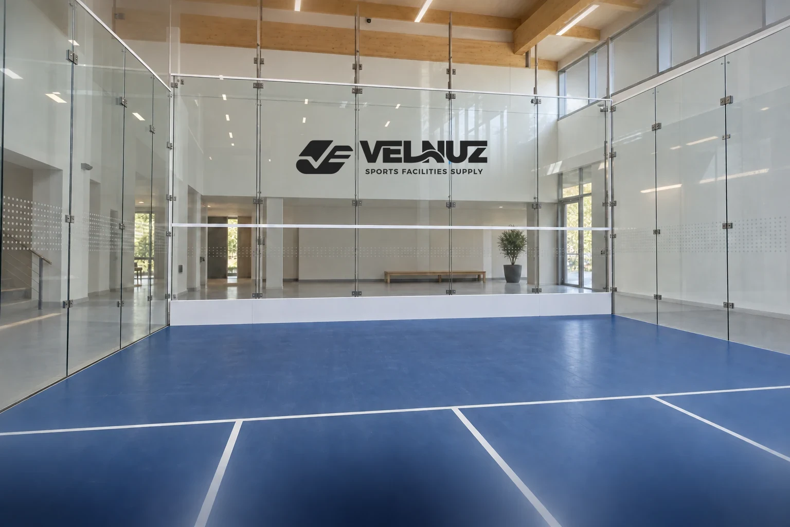 Illustrative all-glass squash court with blue playing surfaces and transparent glass walls