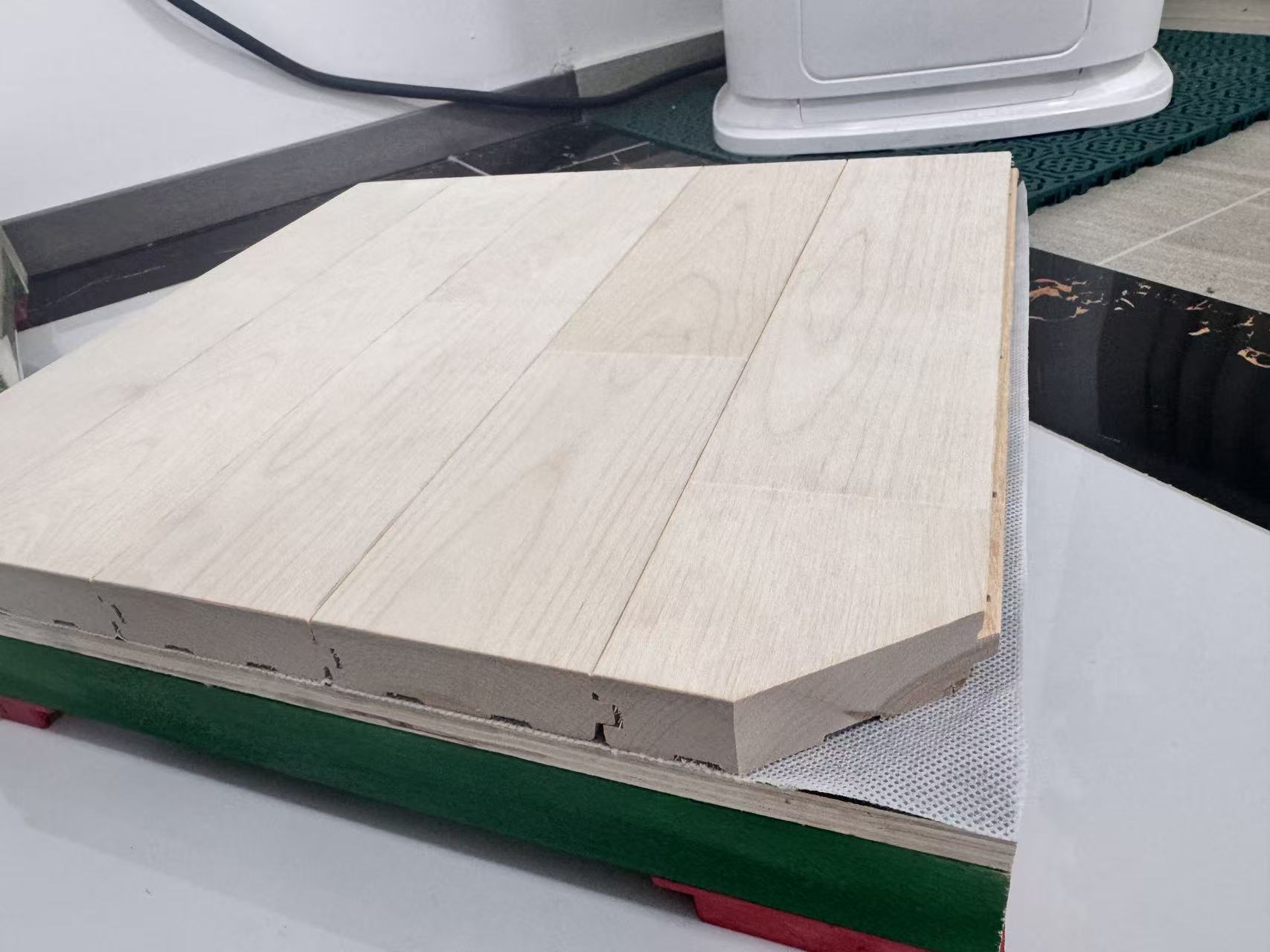 Actual maple playing floor and layered subfloor sample